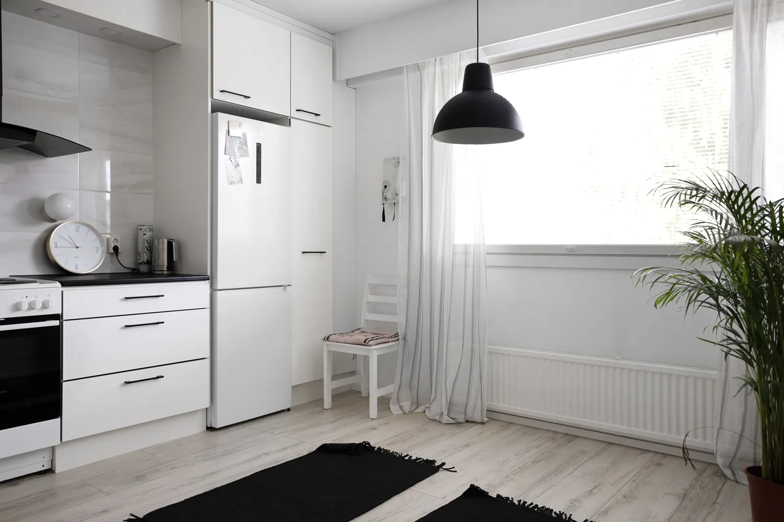 A bright, airy room with natural light falling across a plain white wall